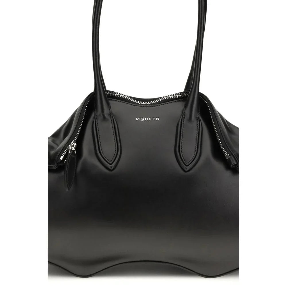 Black luxury leather tote bag with double handles and visible zipper detailing