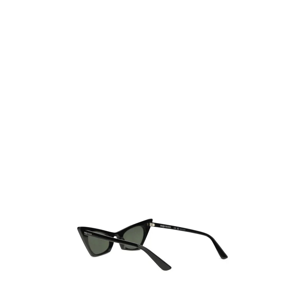 Black cat-eye sunglasses with green lenses on white background, luxury accessory