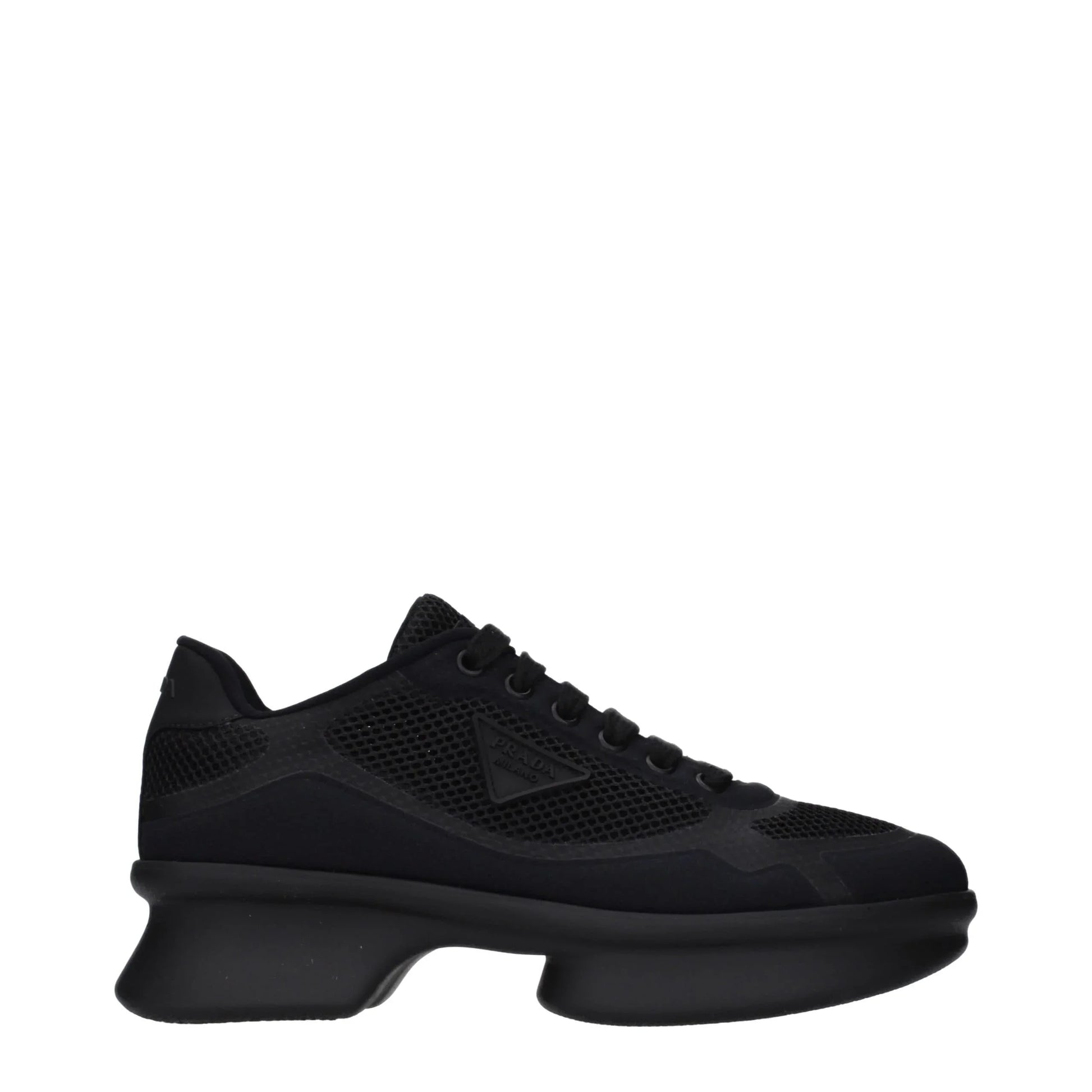 Black designer sneaker with mesh panels and chunky sole, side logo detail visible