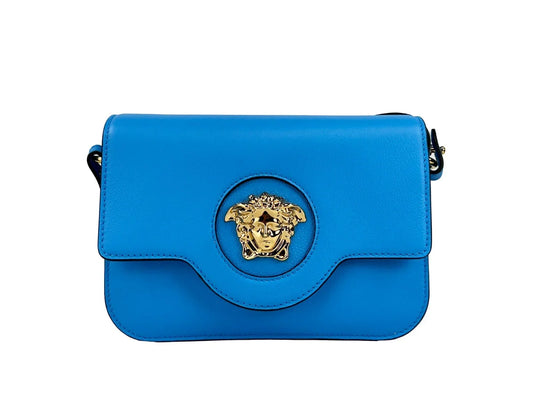 Blue leather crossbody bag with gold Medusa emblem on front flap, luxury designer accessory