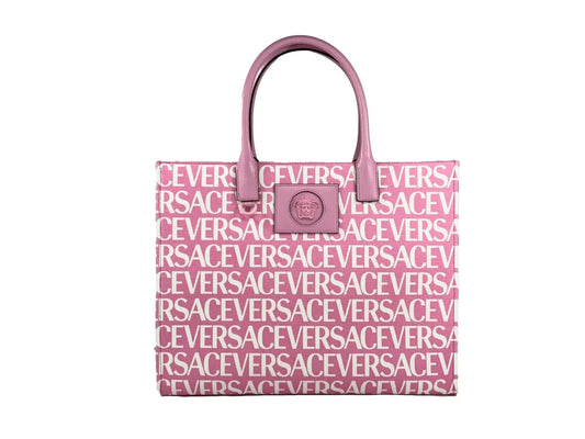 Pink luxury tote bag with white all-over logo print and top handles, isolated on white