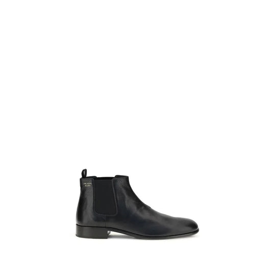 Black leather Chelsea boot with low heel and elastic side panel on white background