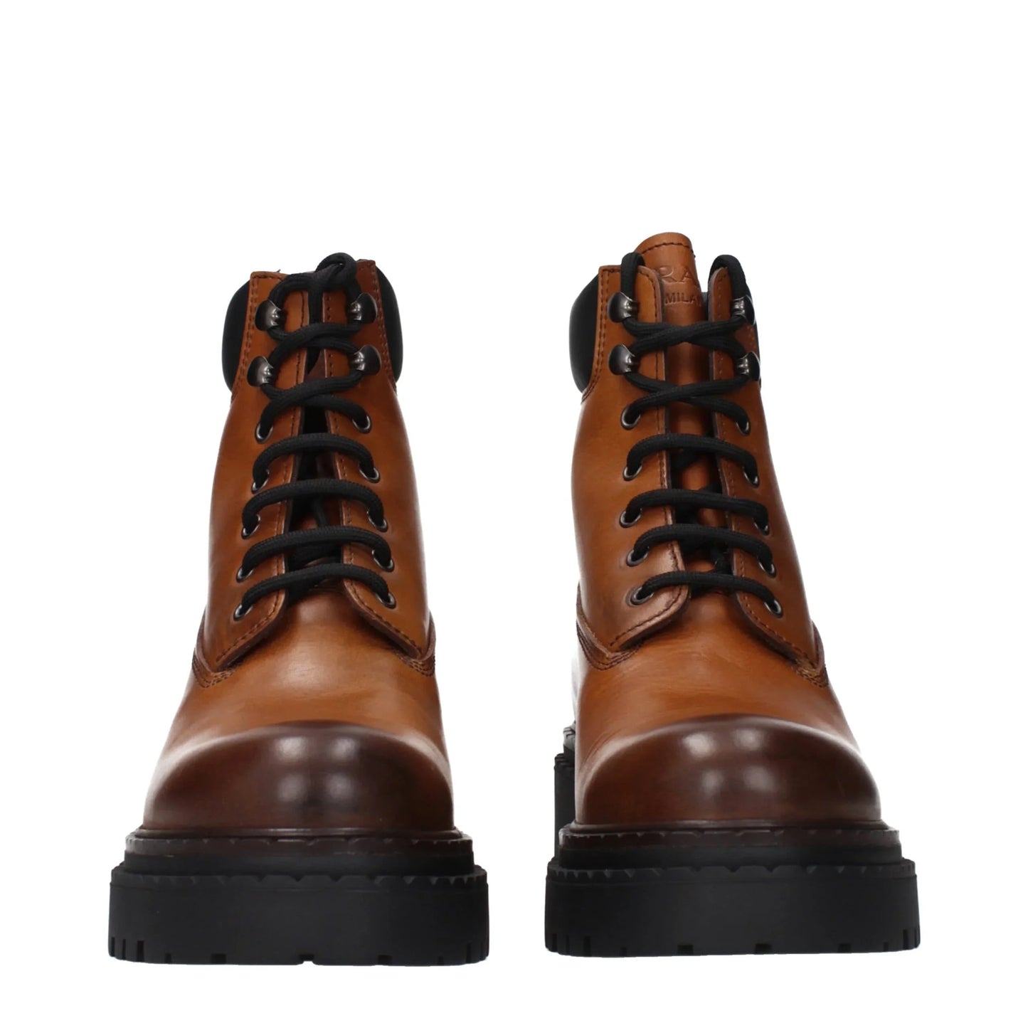 Brown leather lace-up combat boots with black soles, front view, on white background